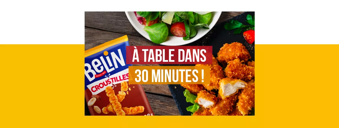 Un paquet de Belin Croustilles est posé près d’une salade et de nuggets.